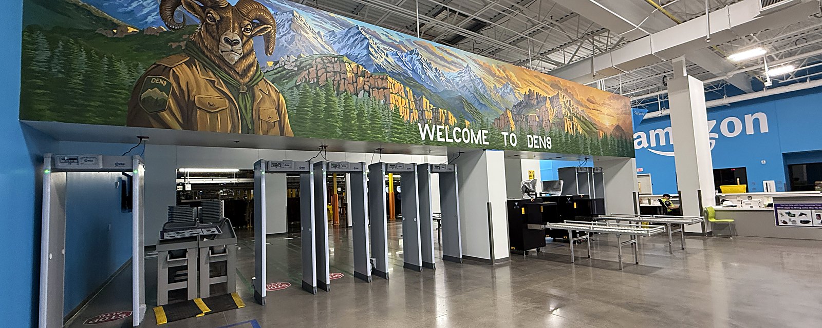 The same wall finished: a bighorn ram and park ranger against the Colorado Rockies at sunset, above the words Welcome to DEN9