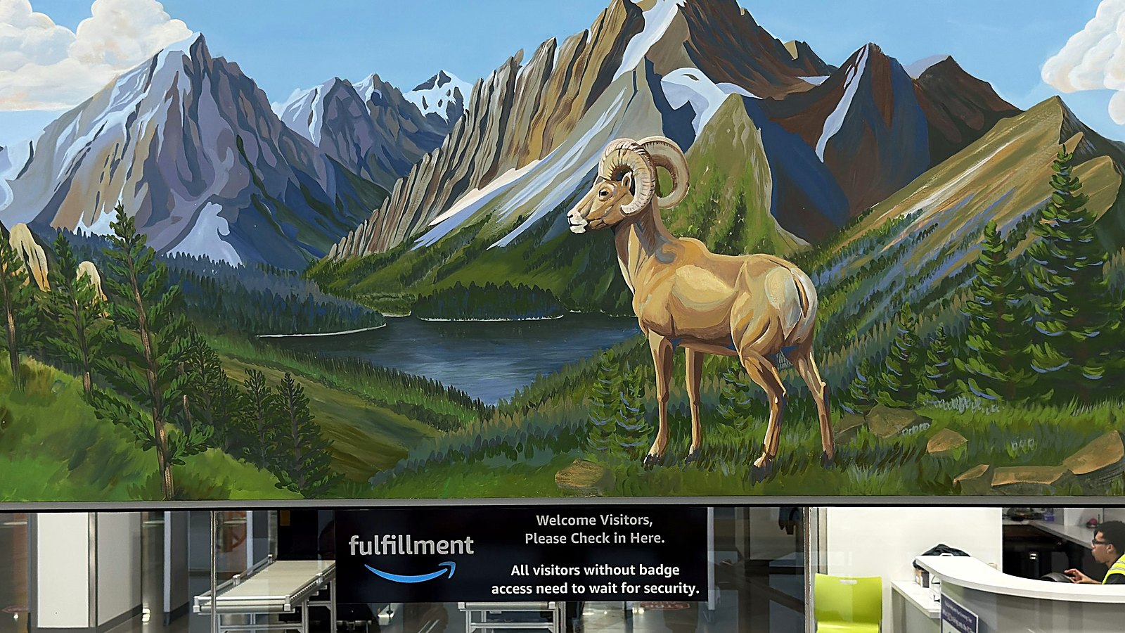 The DEN9 visitor entrance mural, a high alpine lake scene with a bighorn ram at close to life size
