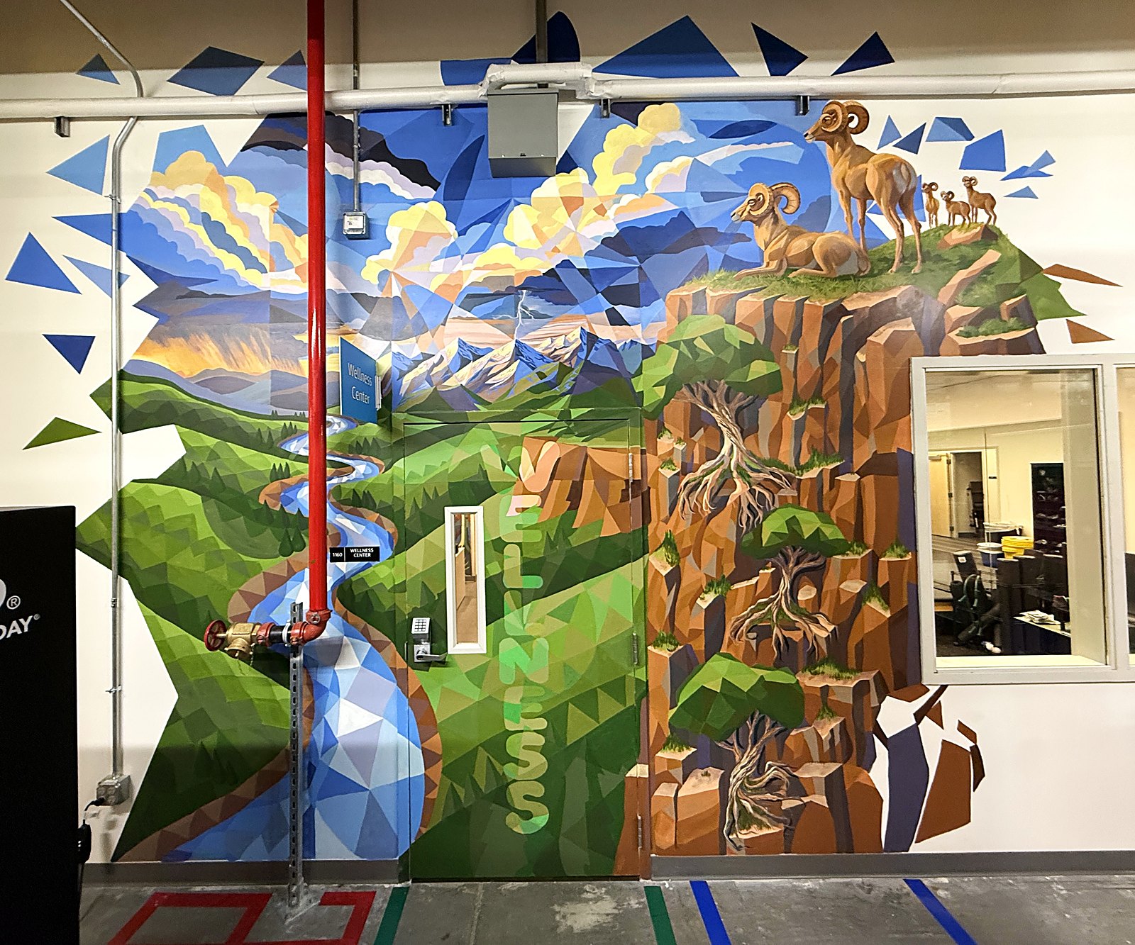 The wellness center entrance mural, a faceted Colorado landscape with rams, a stream and trees growing from rock, composed as a kaleidoscope of Platonic solids